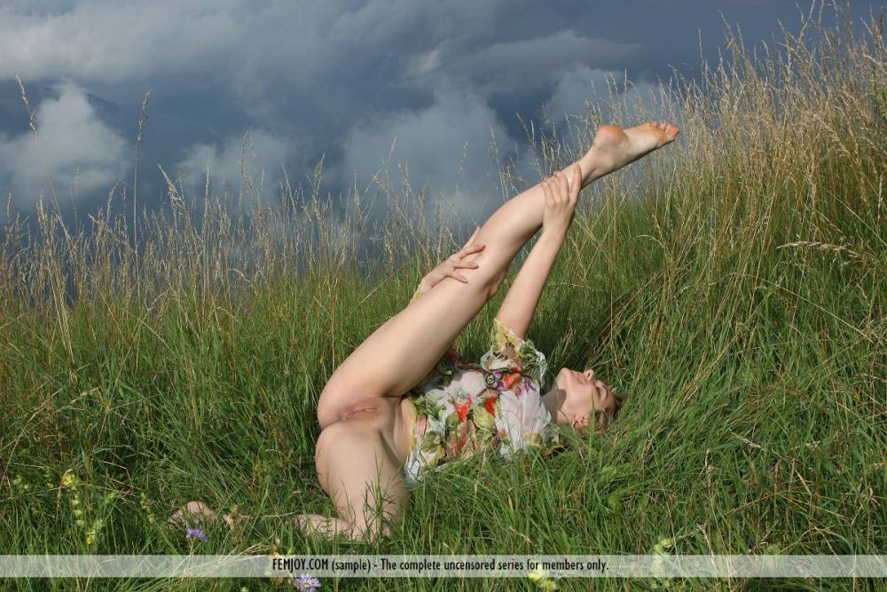 Nature girl Thea C hikes her dress to spread long legs & bald pussy in a field - #11