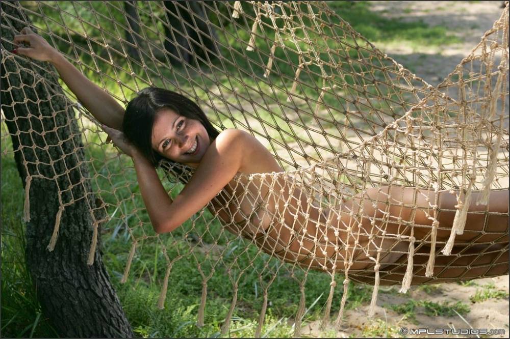 Totally naked teen eats cherries while lounging on a seaside hammock - #3