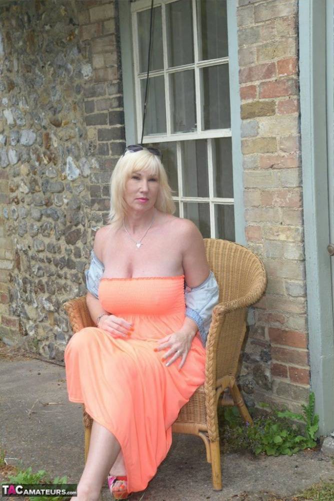 Mature lady with blonde hair takes off glasses before unveiling her great tits - #13