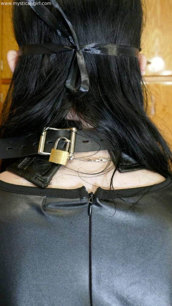 Collared solo woman models leather clothing while wearing a mask - #15