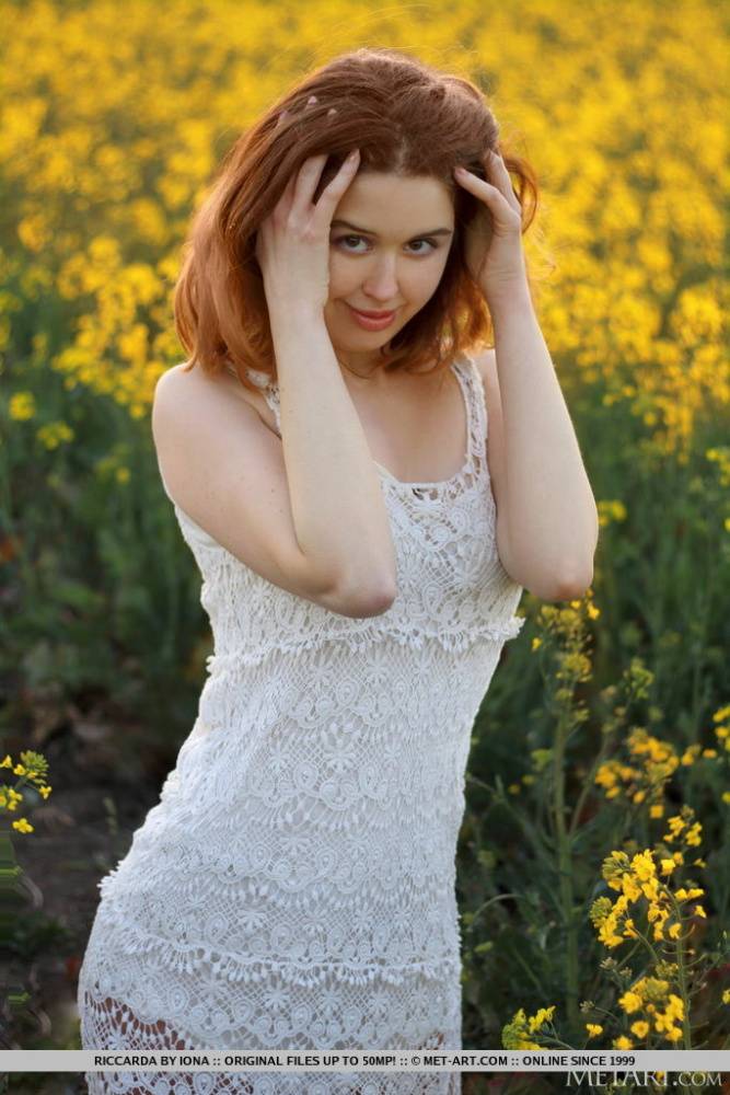 Young redhead Riccarda models in a mustard field before getting naked - #9
