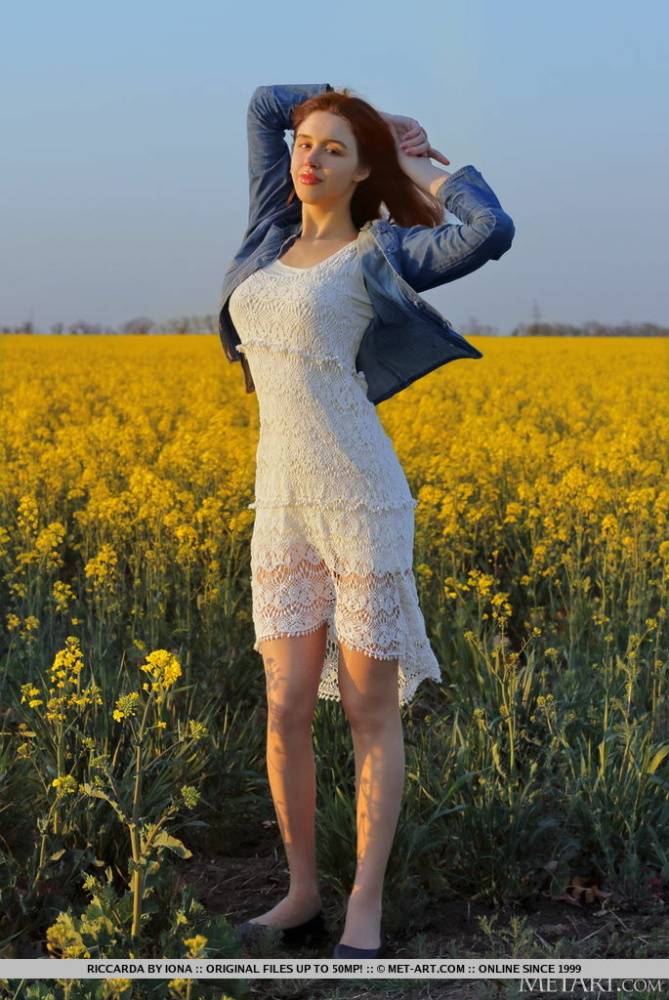 Young redhead Riccarda models in a mustard field before getting naked - #10
