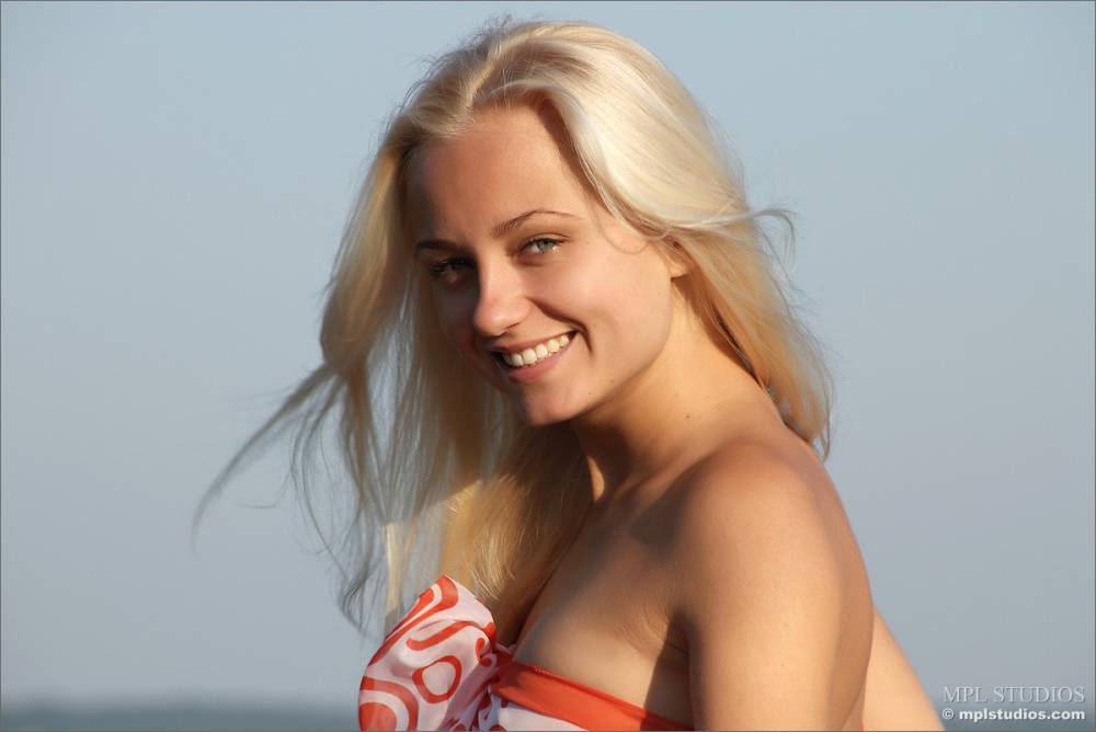 Smiling pretty blonde disrobes by the lake to play naked with tiny tits bare - #3