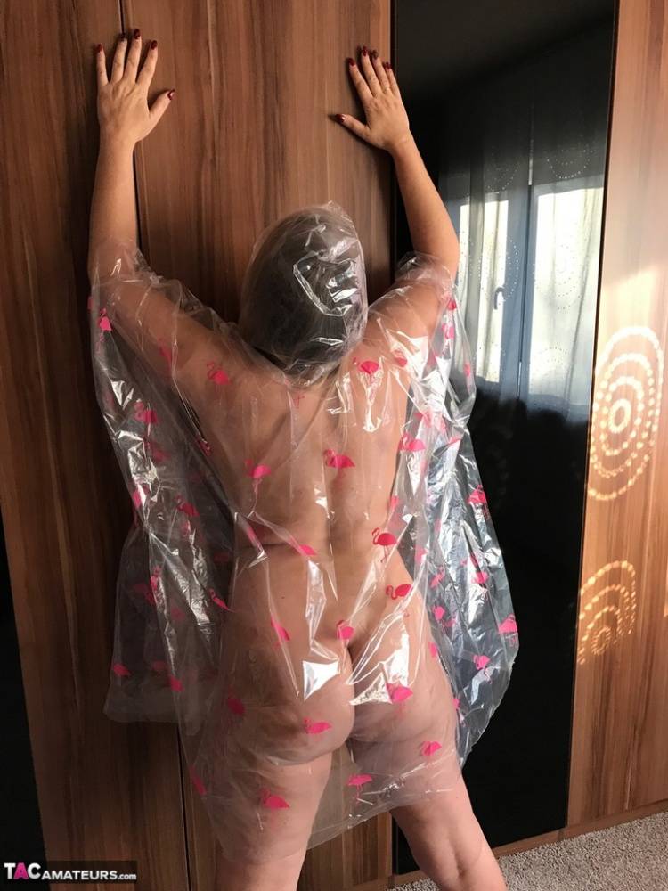 Thick amateur Sweet Susi poses nude while draped in a disposable raincoat - #11