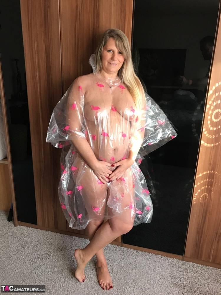 Thick amateur Sweet Susi poses nude while draped in a disposable raincoat - #8