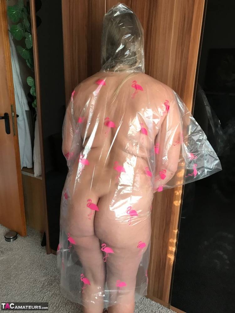 Thick amateur Sweet Susi poses nude while draped in a disposable raincoat - #7