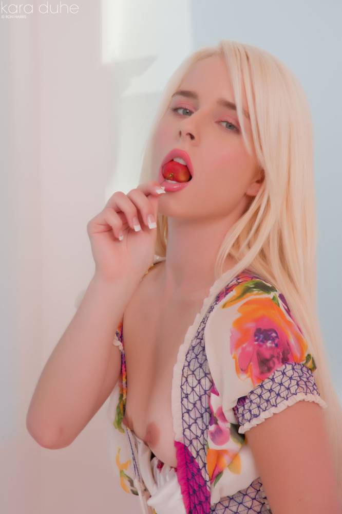Petite blonde Kara Duhe eating a cherry with her dress open to show tiny tits - #9