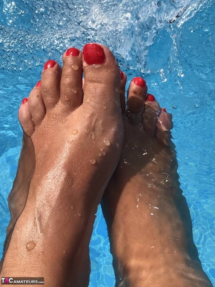 Mature woman Sweet Susi dips her painted toenails into a swimming pool - #15