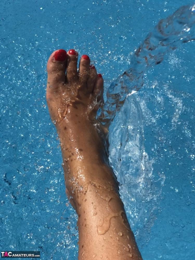 Mature woman Sweet Susi dips her painted toenails into a swimming pool - #9