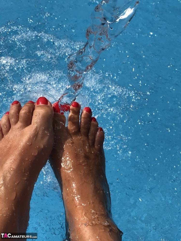 Mature woman Sweet Susi dips her painted toenails into a swimming pool - #13