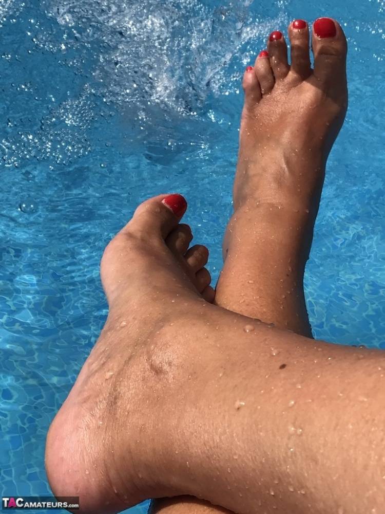 Mature woman Sweet Susi dips her painted toenails into a swimming pool - #12