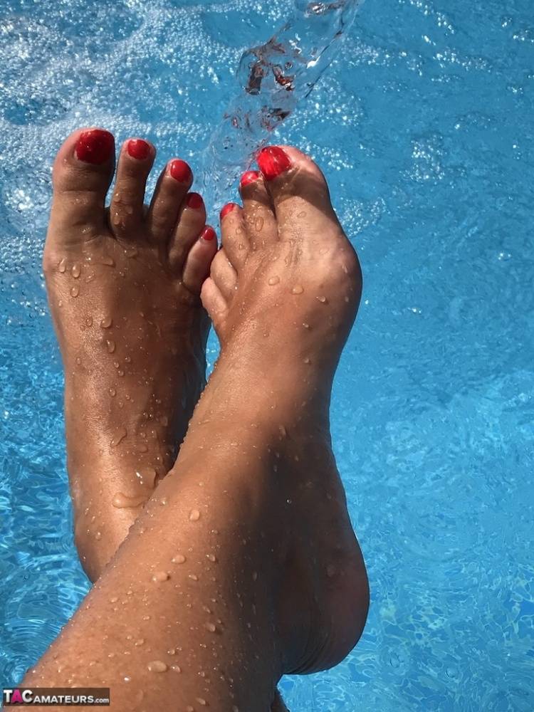 Mature woman Sweet Susi dips her painted toenails into a swimming pool - #10