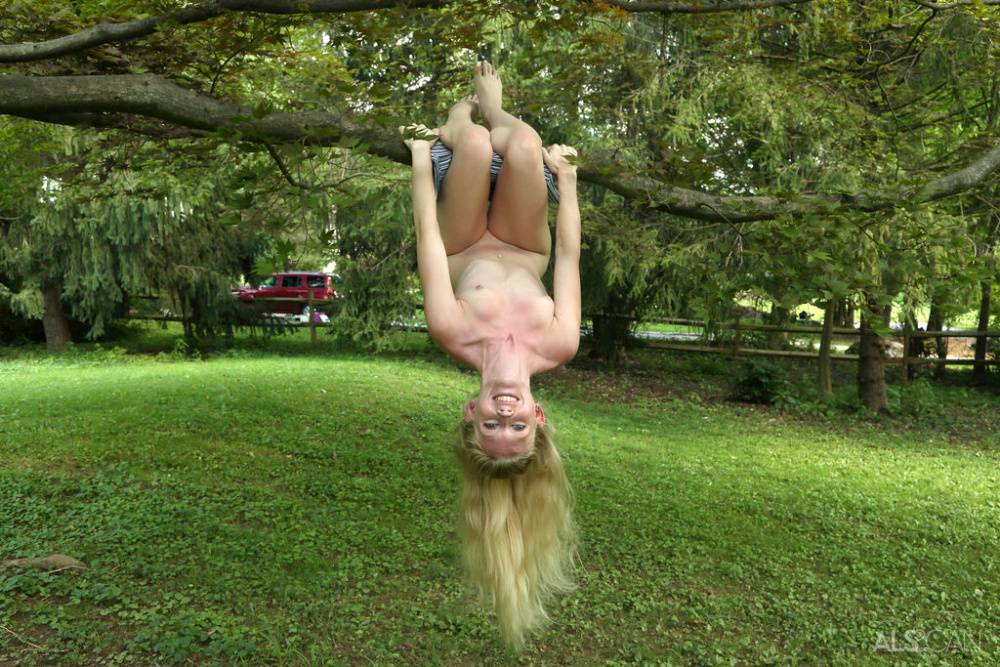 Cute blonde Emma Starletto shows off her flexibility while naked in the yard - #12