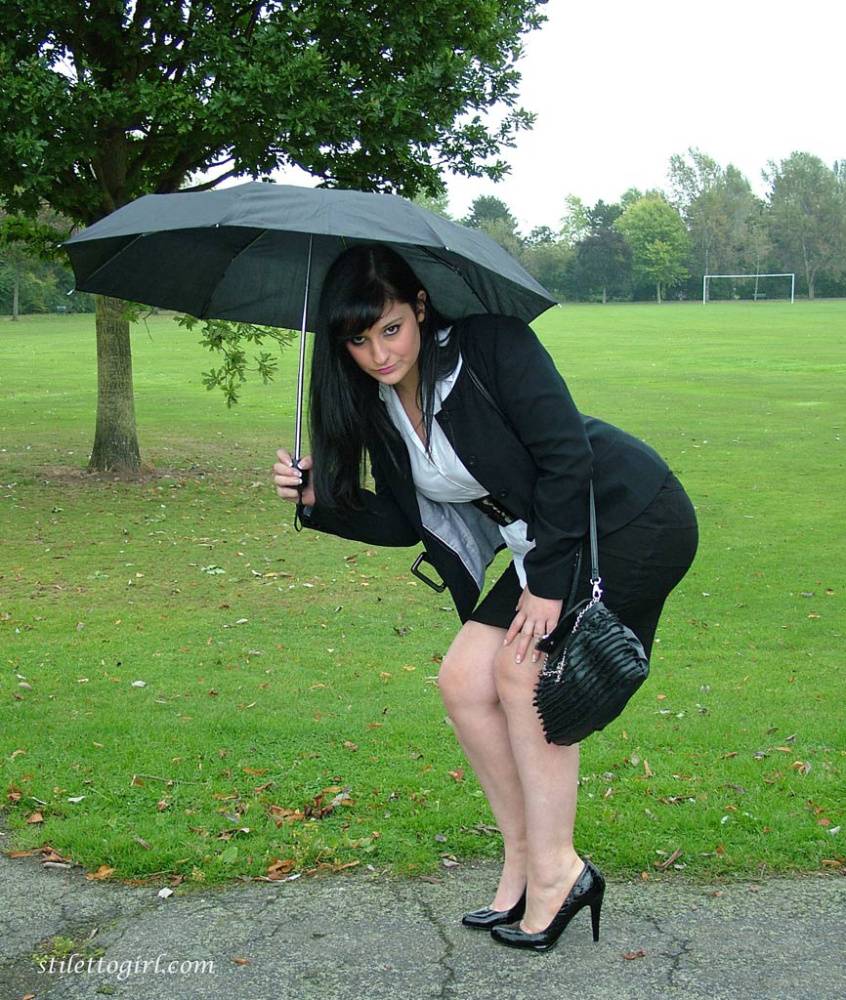Fully clothed model Nicola takes a walk on park pathway in her new black pumps - #7