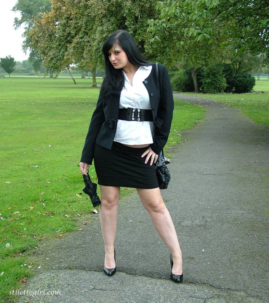 Fully clothed model Nicola takes a walk on park pathway in her new black pumps - #1
