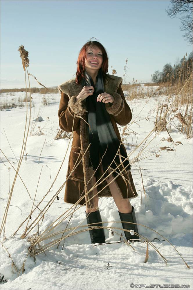 Sexy redhead poses in the nude in boots out on a snow covered field - #7