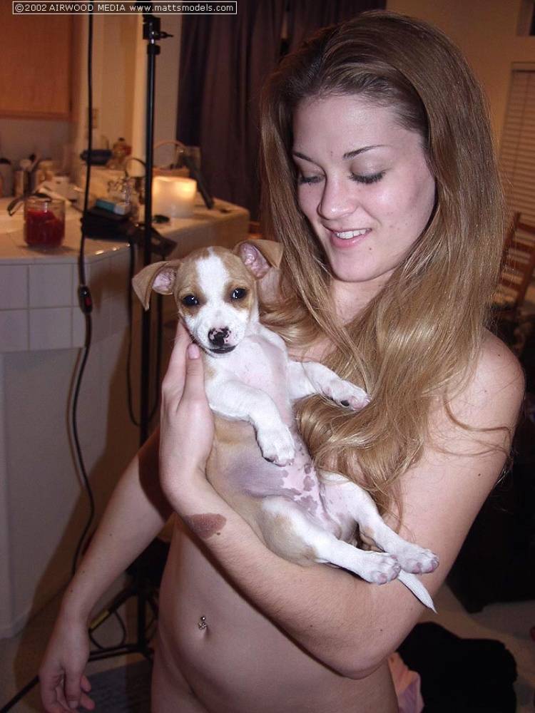 Redhead amateur Britney holds a puppy in her arms while completely naked - #15
