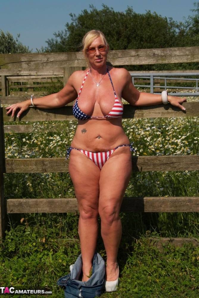 Busty mature slut Melody sheds bikini top outdoors to sun massive tits - #4