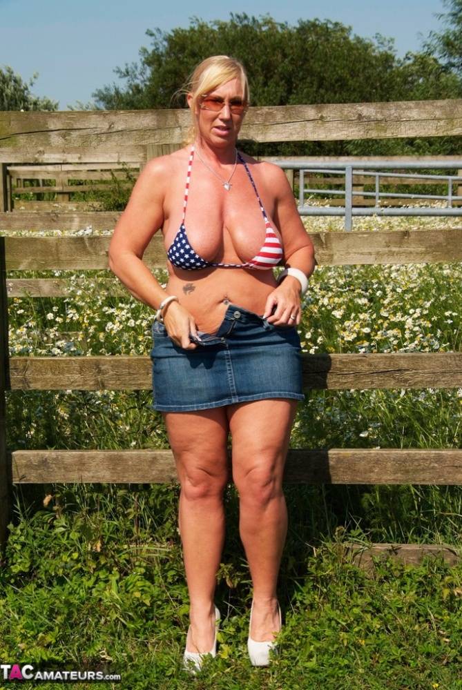 Busty mature slut Melody sheds bikini top outdoors to sun massive tits - #7
