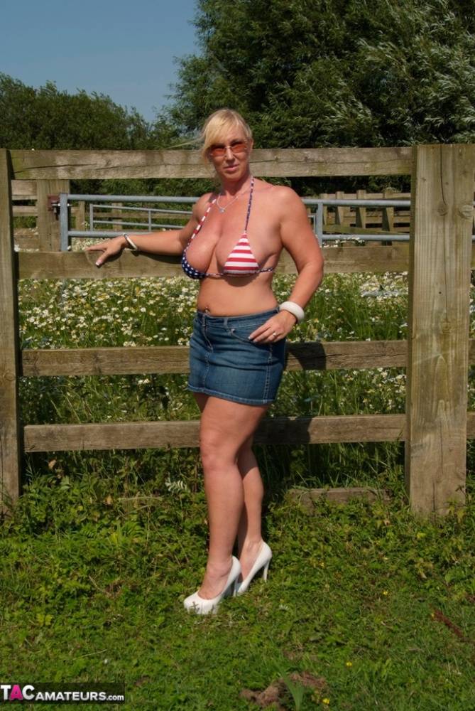 Busty mature slut Melody sheds bikini top outdoors to sun massive tits - #16