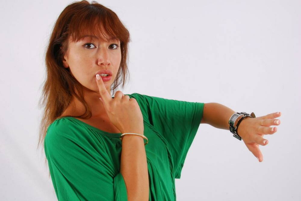 Redheaded Asian girl Evita models a Guess style cuff watch during SFW action - #12