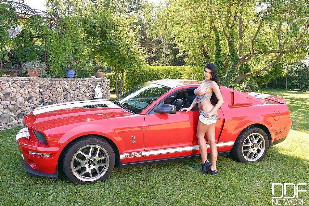 Busty brunette babe Lucy Li posing topless outdoors next to sports car - #6
