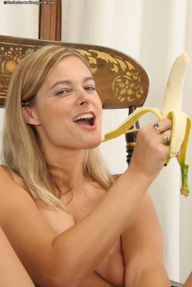 Naughty blonde MILF with sexy curves pleasing her cunt with a banana - #3