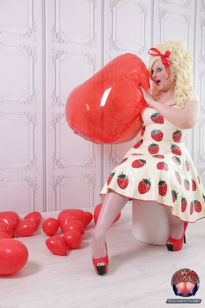 Thick blonde Avengelique models a latex dress in hosiery and red heels - #10