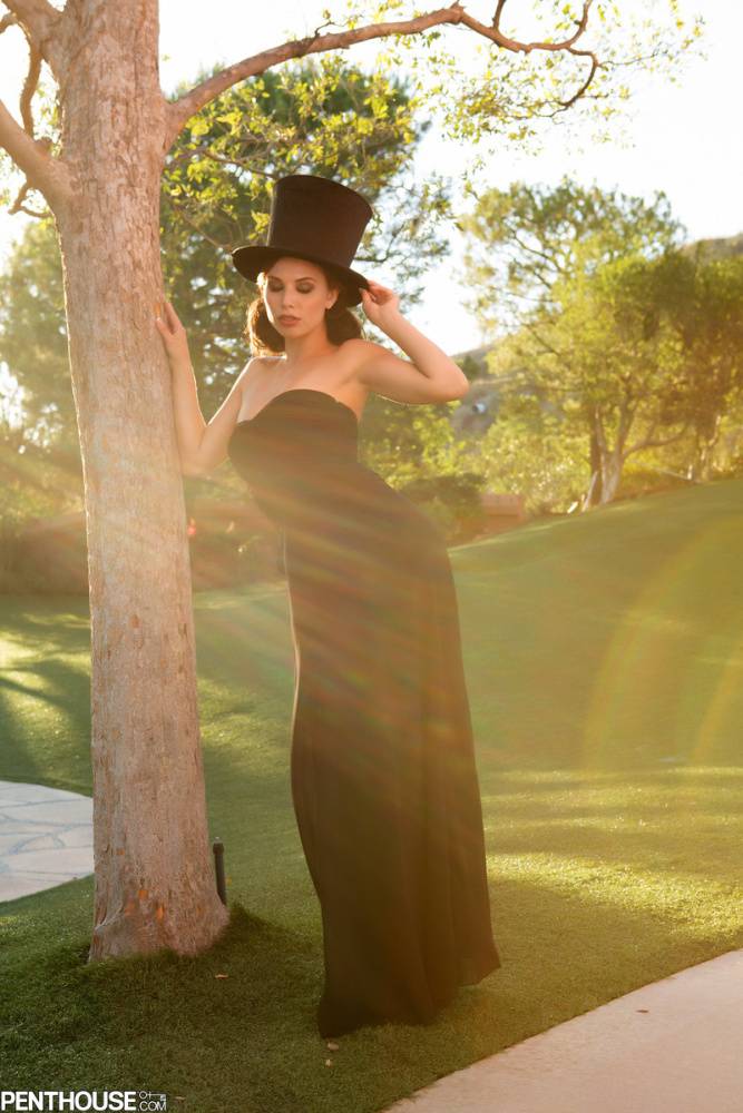 Sexy female Aidra Fox doffs a black dress and top hat to pose nude in a yard - #11