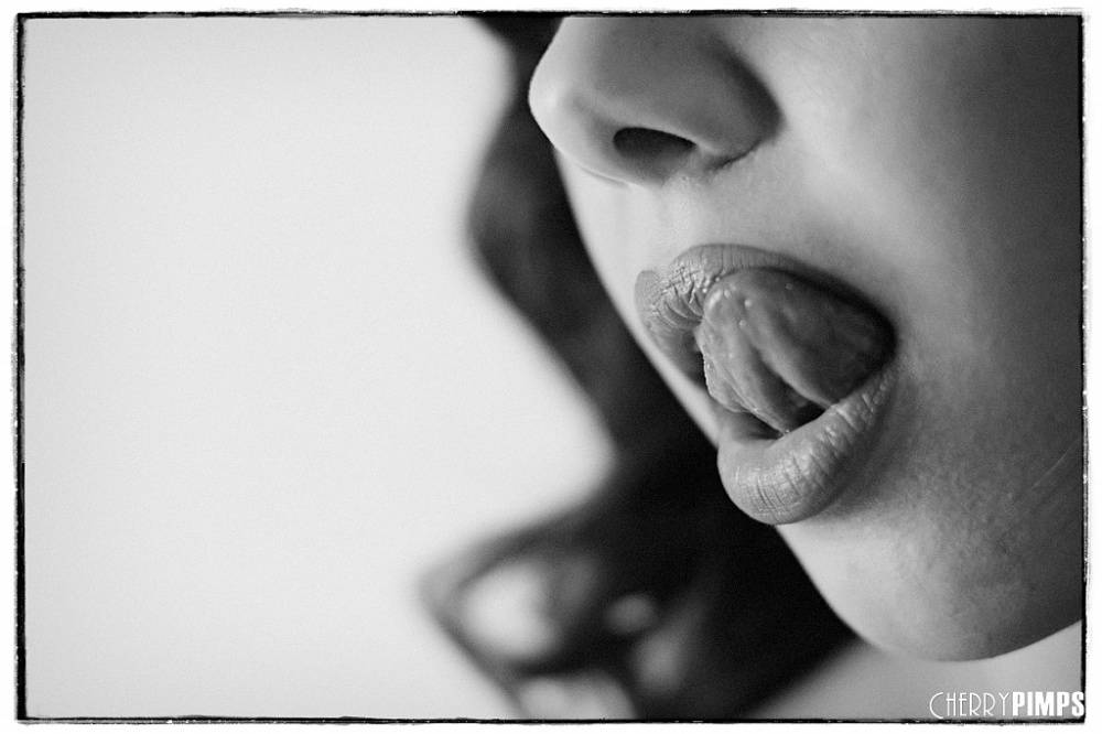 Solo model Jenna Sativa licks her lisp as she works free of a black onesie - #3