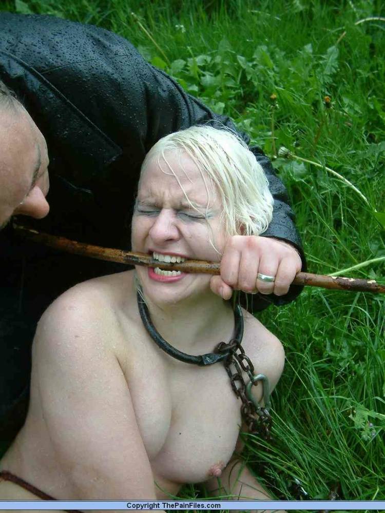 Naked blonde slave is caned and stomped on in a field of lush grass - #15