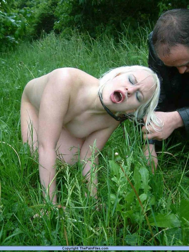 Naked blonde slave is caned and stomped on in a field of lush grass - #12
