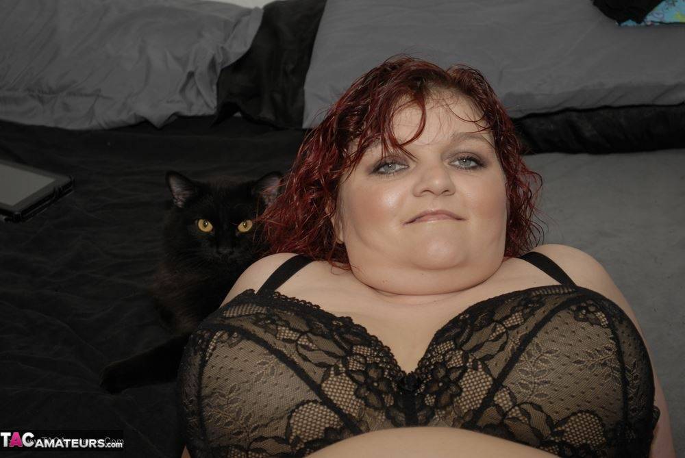 Redheaded BBW Black Widow AK models on her bed in a black bra and panty set - #4