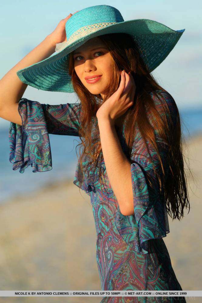 Teen beauty Nicole K modeling naked on beach wearing a sun hat - #11