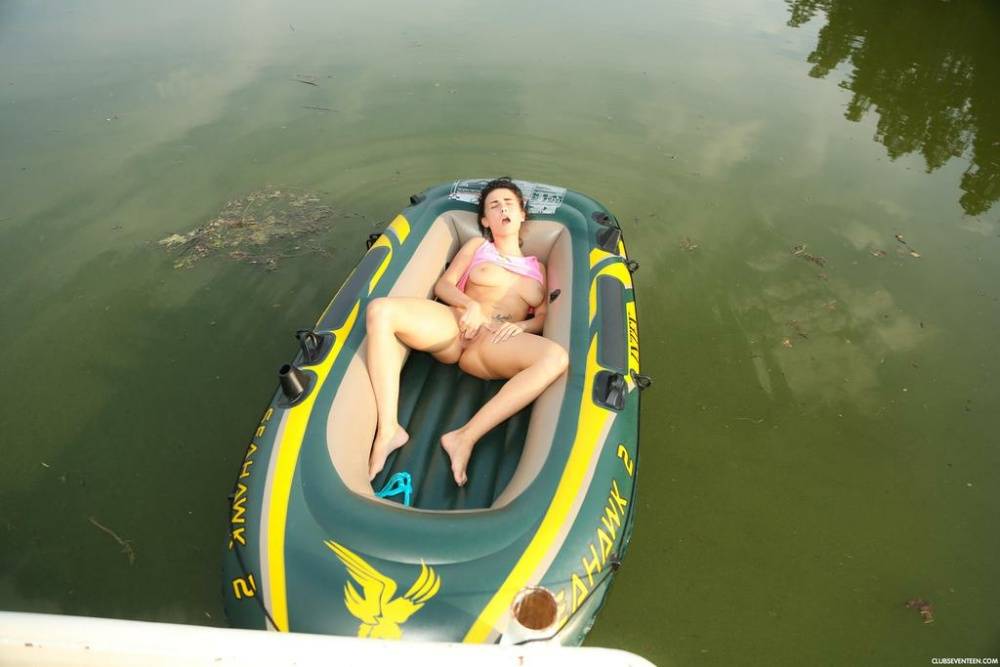European teen with a flawless body relaxes in a small boat rubbing her snatch - #1