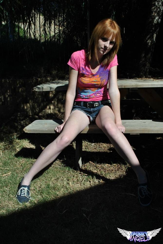 Young redhead Kate Cooper hikes her skirt and flashes her twat against a fence - #12