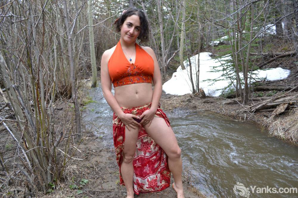 Busty amateur pets her beaver while bent over next to a brook in the woods - #12