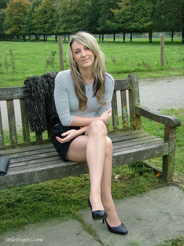 Leg model poses on a country bench in black skirt and pumps - #13