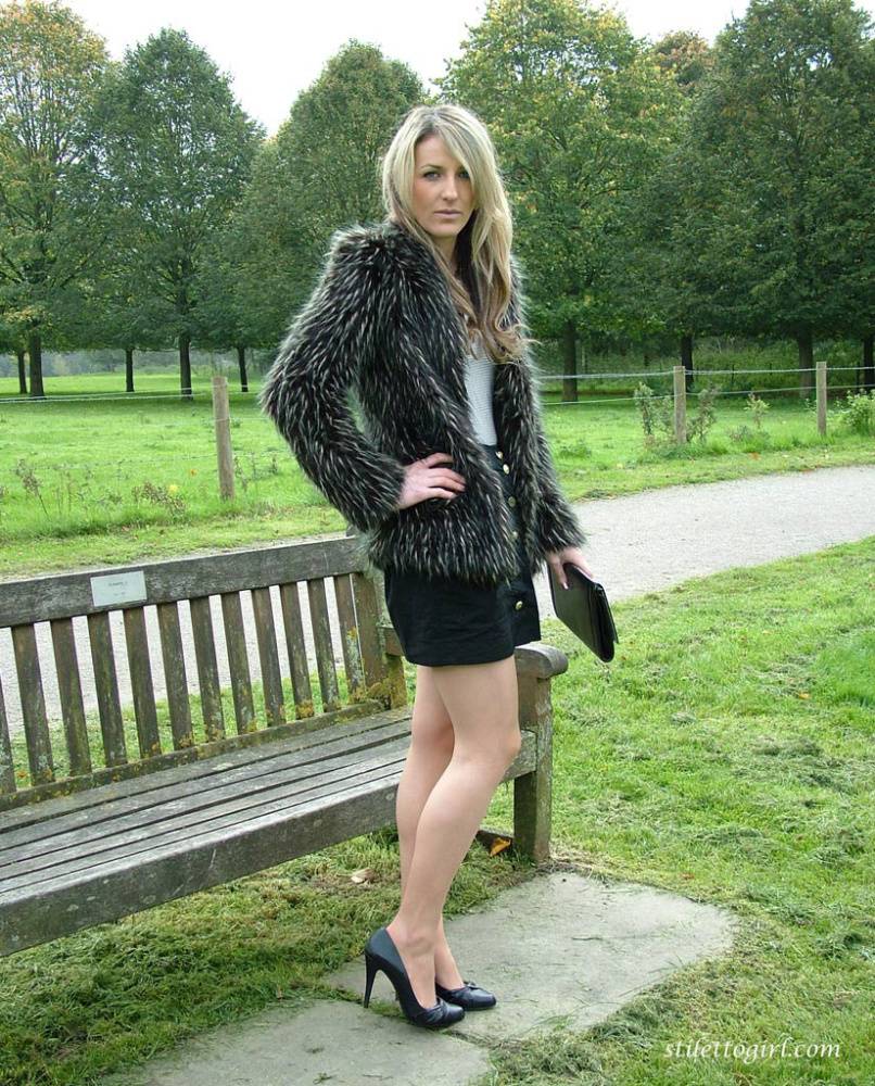 Leg model poses on a country bench in black skirt and pumps - #1