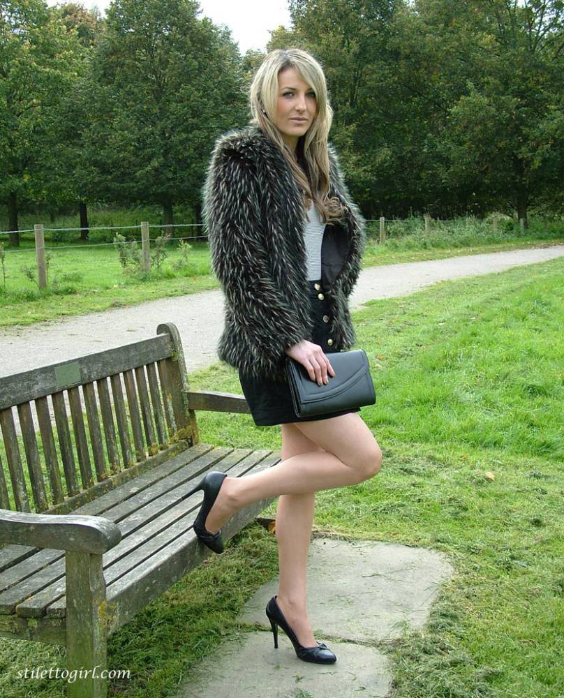 Leg model poses on a country bench in black skirt and pumps - #4