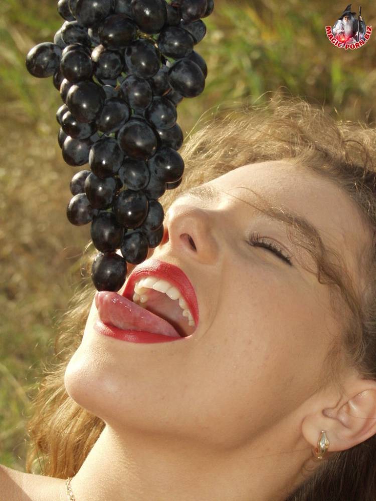 Teen amateur licks a bunch of grapes while bare naked on a hilly field - #1