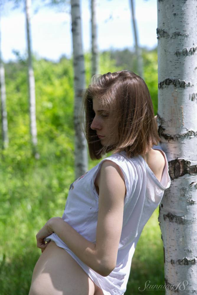 Skinny 18-year-old Anna R grabs her tight ass and snatch against a birch tree - #1