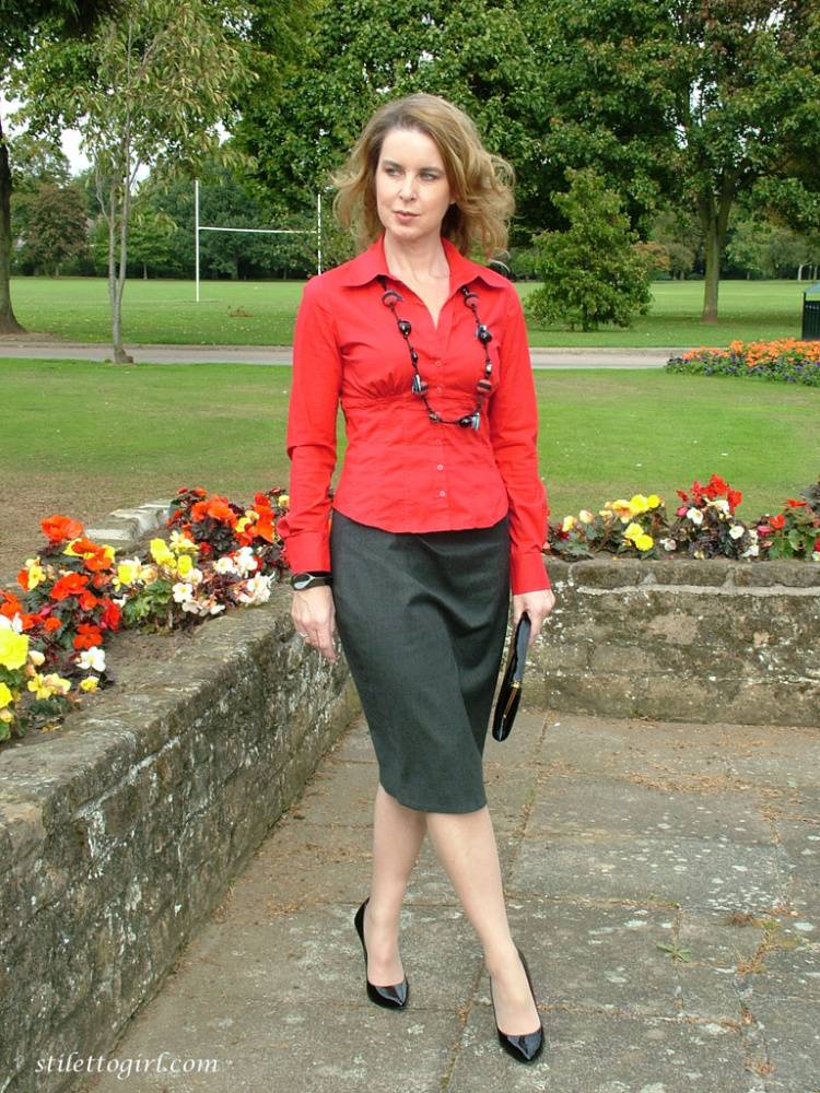 Fully clothed woman steps out of a stiletto heel while visiting a public park - #7