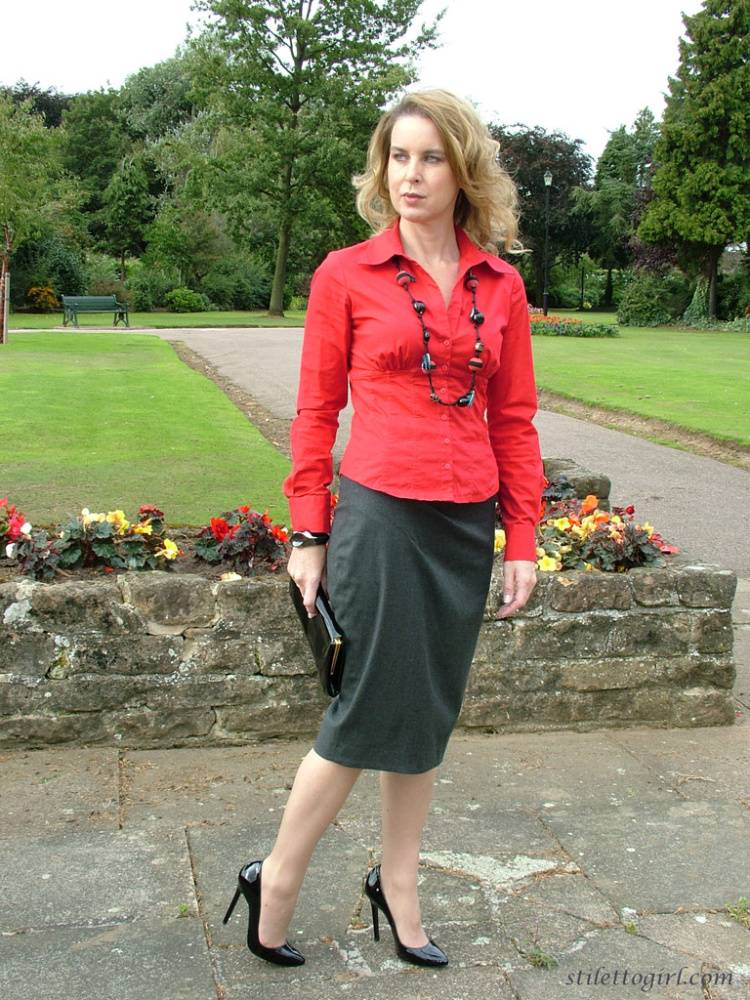 Fully clothed woman steps out of a stiletto heel while visiting a public park - #15