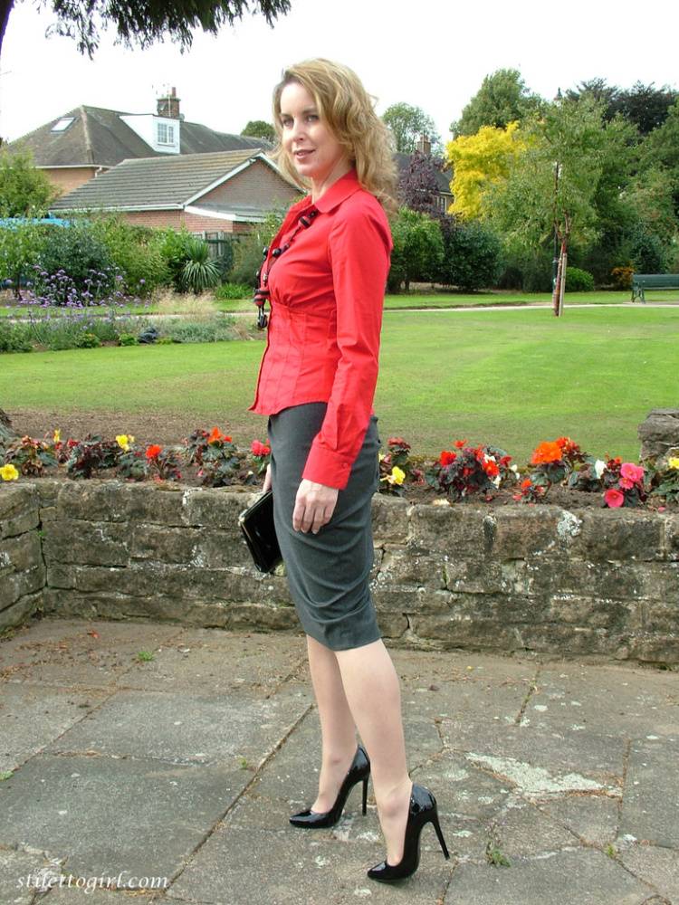 Fully clothed woman steps out of a stiletto heel while visiting a public park - #10