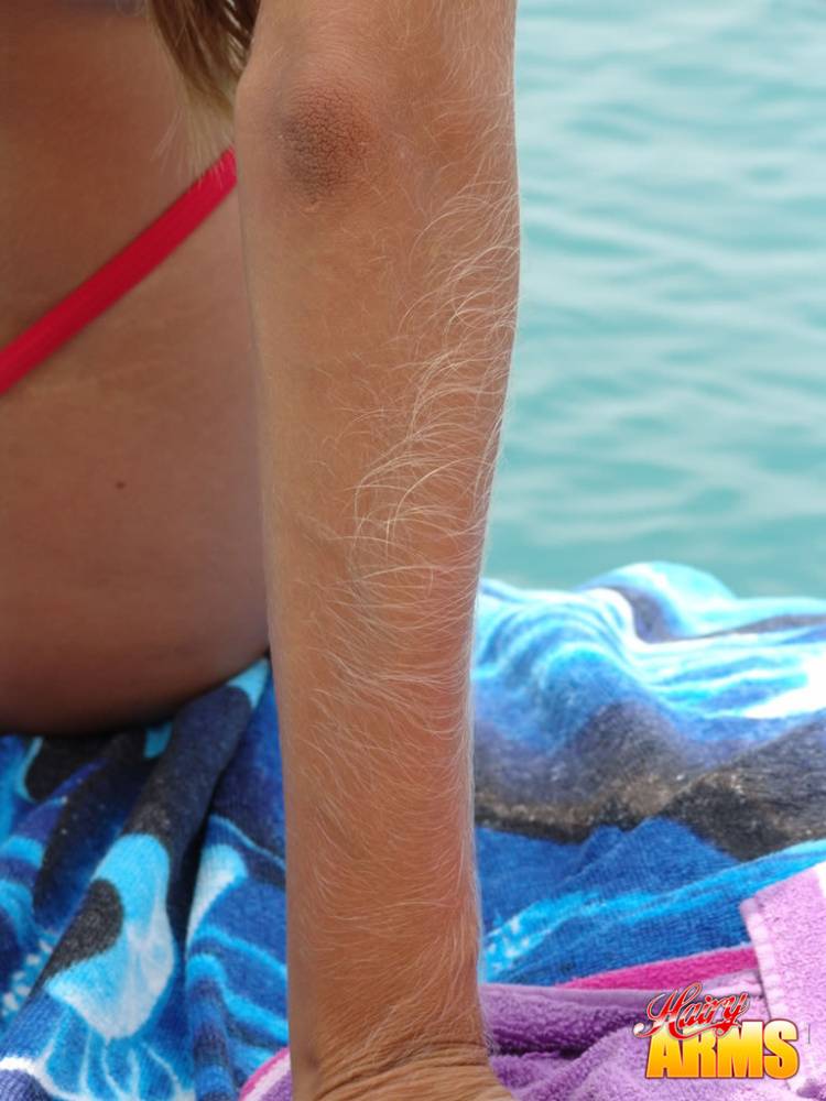 Middle-aged amateur with hairy arms models in a bikini next to the ocean - #14