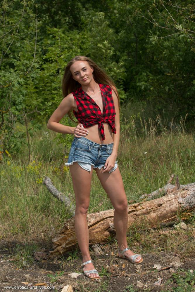 Slim teen Andrea Sixth strips to her footwear on a log in nature - #7
