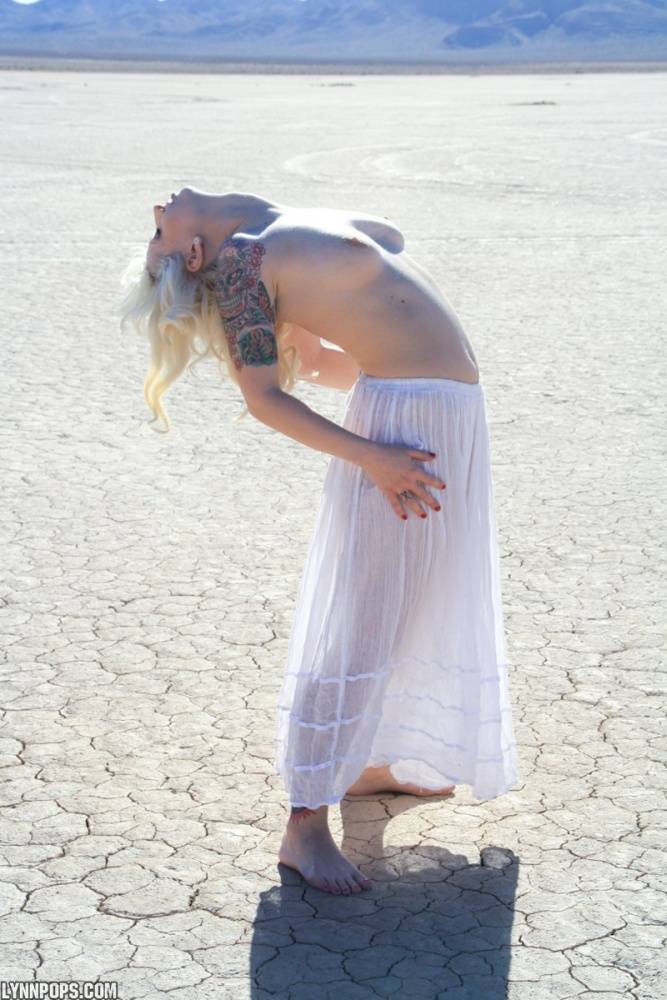 Sexy blonde Lynn Pops goes topless on a dry lake before exposing her vagina - #12