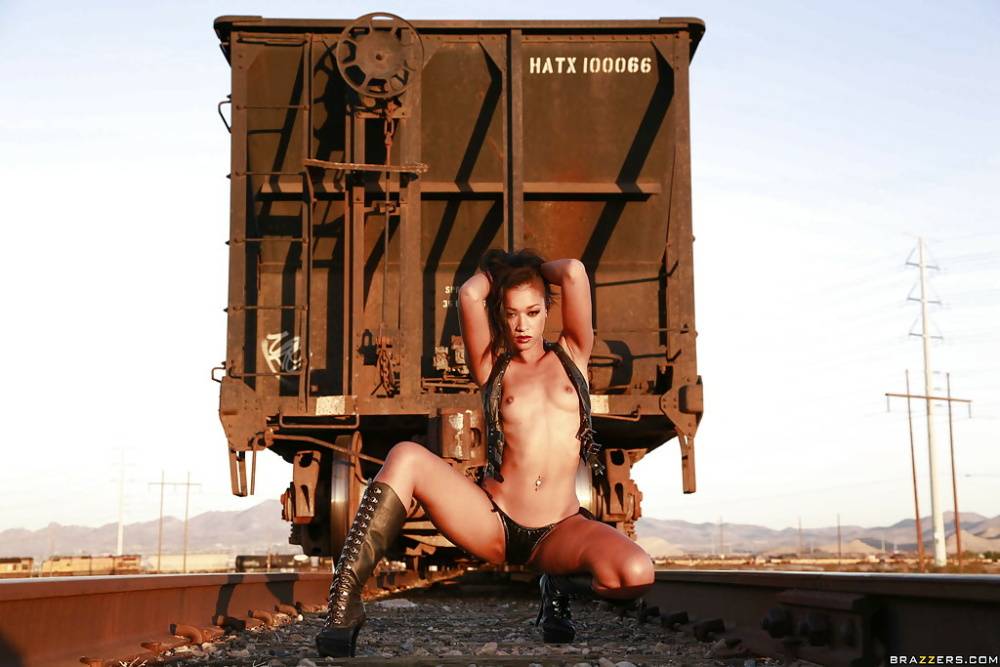 Tattooed babe Skin Diamond poses in her boots outdoor at the train - #8