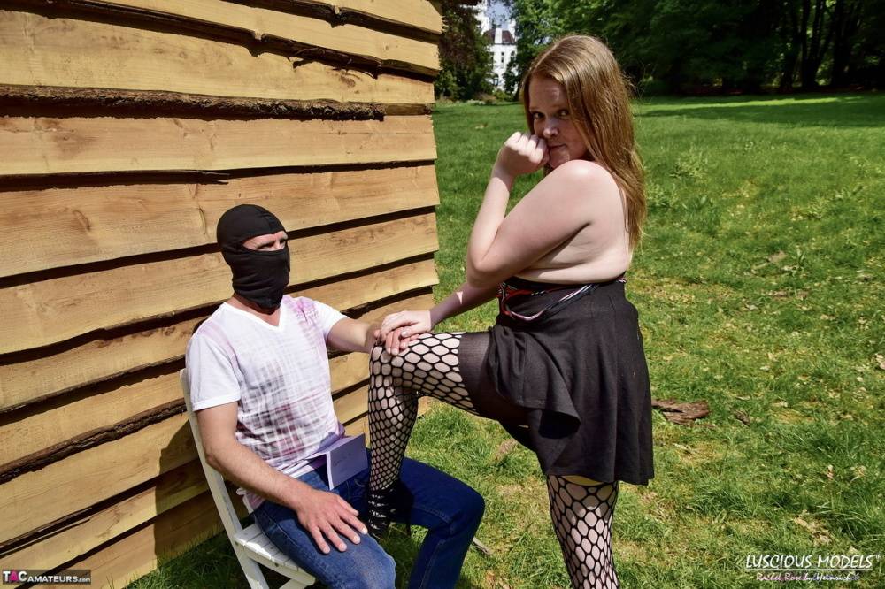Natural redhead masturbates on a lawn before teasing a masked man - #9